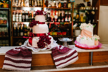 A delicious sweet wedding loaf in the Ukrainian style on embroidered towels. Festive sweet table.