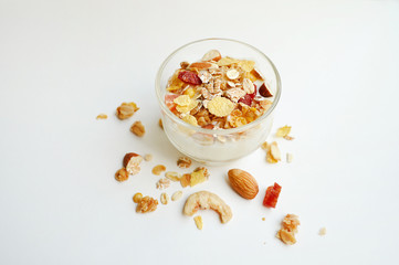 Muesli, granola with yogurt in bowl on white background