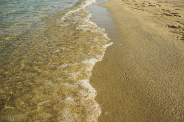 idyllic yellow sand beach and soft blue shoreline water waves in summer vacation conceptual photography outdoor natural wilderness landscape simple background wallpaper pattern with empty