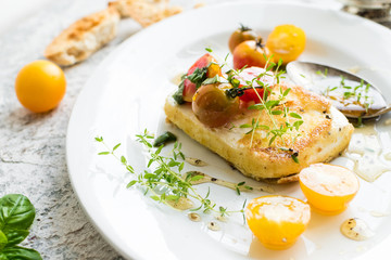 Pan-fried salty feta cheese coated in breadcrumbs