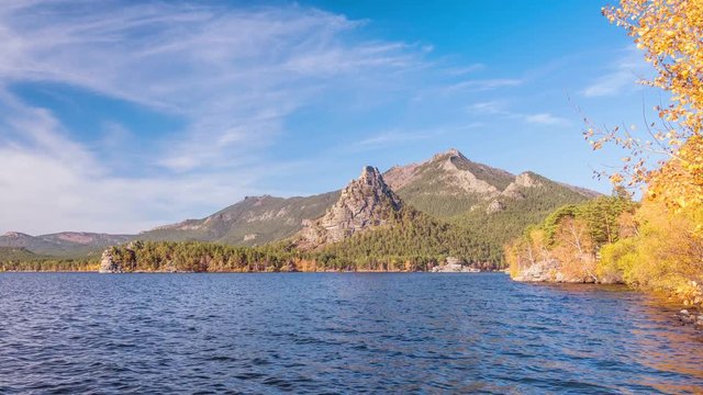 Majestic nature of Kazakhstan concept: epic view of Burabay lake with Okzhetpes and Zhumbaktas rocks from the highest point of Sinyuha Mountain at sunset in autumn season; time lapse zoom in