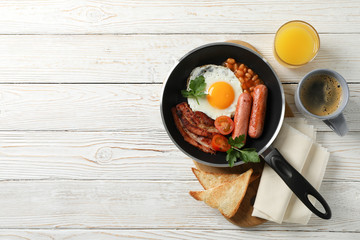 Delicious breakfast or lunch with fried eggs on wooden background, top view