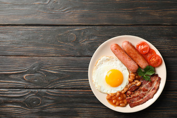Delicious breakfast or lunch with fried eggs on wooden background, top view