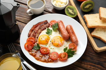 Delicious breakfast or lunch with fried eggs on wooden background, close up