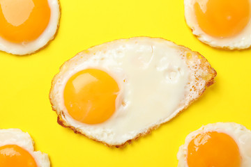 Flat lay composition with cooked eggs on yellow background, top view