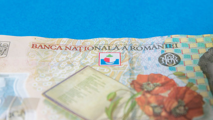 Romanian banknotes on a blue and red background. Coloseup of RON, Romanian Currency. Romanian RON, Lei Banknotes issued by BNR, National Bank of Romania. Romania Finance and economy concept