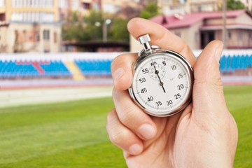 Classic metal stopwatch in human hand