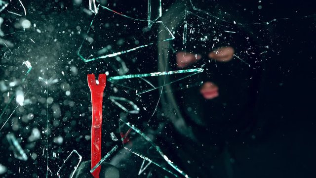 Super Slow Motion Shot of Robbery Concept at 1000 fps Isolated on Black Background.
