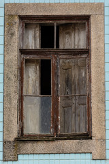 Old wood window half open. Blue portuguese tiles