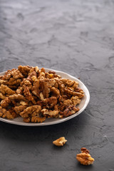 Fresh, peeled walnuts before chopping in a blender on a gray background