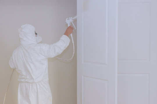 Master painting wood doors with spray gun processing painting door house