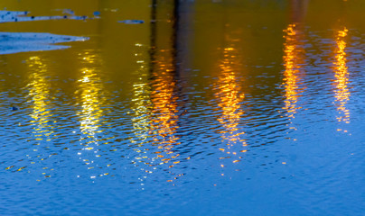 Reflection of light from streetlights on wet asphalt.