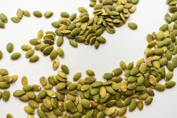 Pumpkin seeds isolated on white background, close up