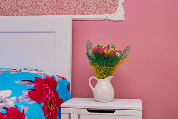 bedroom with flowers,bedroom with white bed and jug with flowers, hotel bedroom decoration