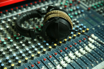 Fototapeta na wymiar sound recording equipment and headphones on a table in a music recording studio