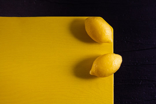Minimalism photo of two yellow small lemons soap on monochrome background.