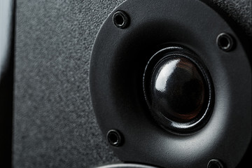 Speaker system speakers in close-up on a black background.