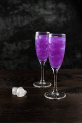 Glitter purple drink in a glass of champagne