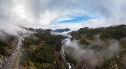 Aerial Panoramic drone view of Sea to Sky Highway during a cloudy winter morning. Taken between Squamish and Whistler, North of Vancouver, British Columbia, Canada. Panorama