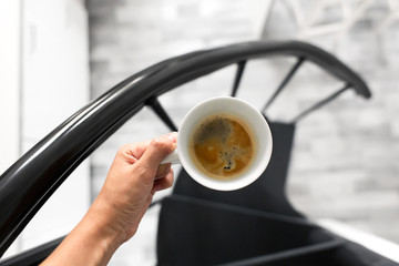 top view of a cup of coffee in hand. Morning aromatic coffee.