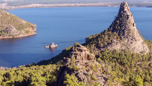 Majestic nature of Kazakhstan concept: epic view of Burabay lake with Okzhetpes and Zhumbaktas rocks from the highest point of Sinyuha Mountain at sunset in autumn season; time lapse zoom in