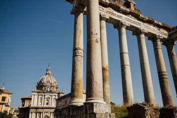 Ancient ruins of the Roman Forum. Ruins of Septimius Severus Arch and Saturn Temple, Rome, Italy. The Sacred Road, the main road of the Roman forum.