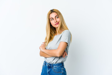 Young blonde woman isolated on white background dreaming of achieving goals and purposes