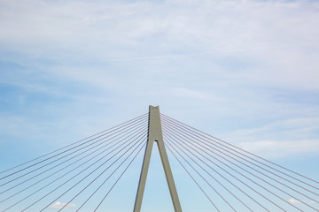 Pylon and steel cables of the bridge across the river rhine close to Neuwied,, Germany, with partly cloudy sky - copy space