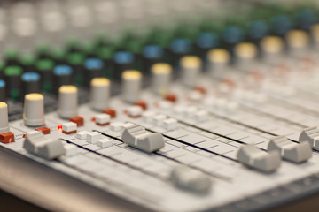 Sound mixer. Close-up. The hand on the remote controls.