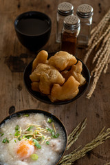 Homemade Thai breakfast, rice porridge and chinese donut on vintage wooden floors