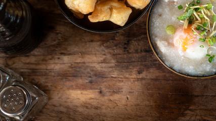Homemade Thai breakfast, rice porridge and chinese donut on vintage wooden floors