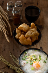 Homemade Thai breakfast, rice porridge and chinese donut on vintage wooden floors