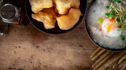 Homemade Thai breakfast, rice porridge and chinese donut on vintage wooden floors