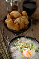 Homemade Thai breakfast, rice porridge and chinese donut on vintage wooden floors