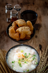 Homemade Thai breakfast, rice porridge and chinese donut on vintage wooden floors
