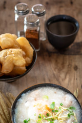 Homemade Thai breakfast, rice porridge and chinese donut on vintage wooden floors