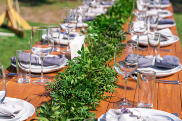 Preparing for an open-air party. Decorated with fresh flowers served tables. Table number. Decoration Details