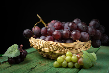 Purple grapes on a chopping block 