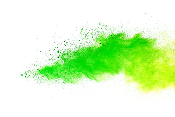 Green and yellow powder explosion on white background.