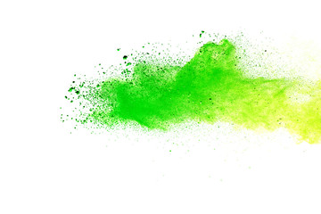 Green and yellow powder explosion on white background.