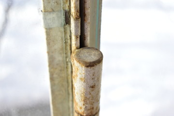 Old rusty locks and hinges on the window