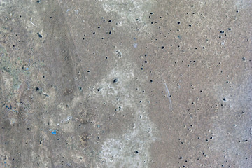 Grey old surface of asphalt and concrete wall