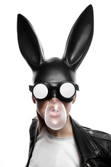 masked easter bunny blowing bubble gum bubbles. Easter party concept