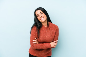 Young caucasian woman isolated on a blue background laughing and having fun.