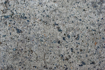 Grey old surface of asphalt and concrete wall