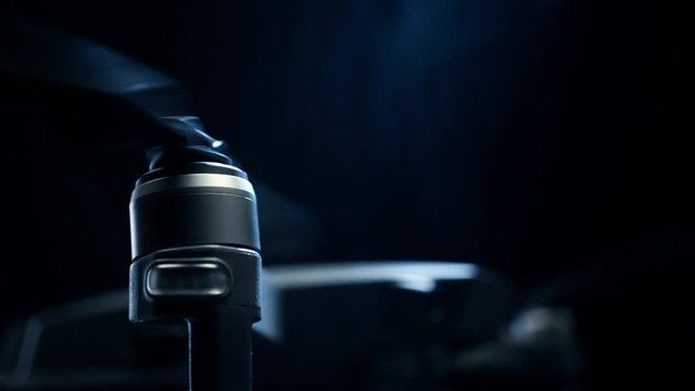 Close-up spinning drone propellers on black background. Modern technologies for shooting photos and videos from above