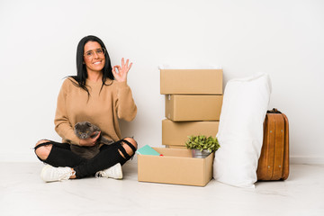 Woman moving home isolated on white background cheerful and confident showing ok gesture.