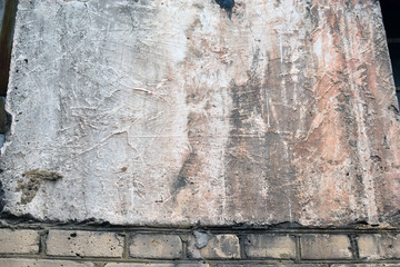 Yellow plastered walls of the house in cracks and damages