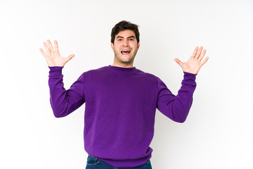 Young man isolated on white background screaming to the sky, looking up, frustrated.