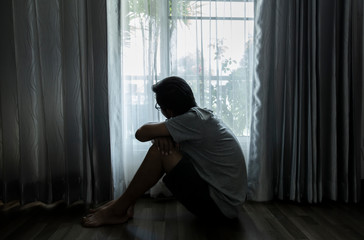 Sad young woman sitting in the bedroom, People with depression concept.	